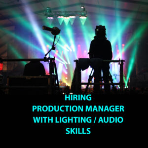 Production manager silhouette in front of stage with special effect lighting